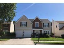 Charming two-story home with a well-manicured lawn and a two-car garage on a sunny day at 3692 Ramsey Cir, Atlanta, GA 30331