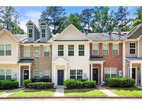 Charming townhouse with neat landscaping and inviting front entrance at 420 Berckman Nw Dr, Lilburn, GA 30047