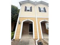 Charming townhouse with brick and siding, featuring a welcoming entrance and black shutters at 602 Summer Pl, Norcross, GA 30071
