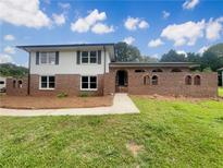 Charming two-story home featuring a brick facade, black shutters, and a well-manicured lawn at 1710 Fontaine Dr, Jonesboro, GA 30236
