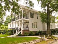 Stately two-story home boasts a charming exterior with double porches, lush landscaping, and mature shade trees at 1764 Defoor Nw Ave, Atlanta, GA 30318