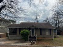 Charming single-story home with a cozy front porch and mature landscaping at 3143 Cedar St, Scottdale, GA 30079