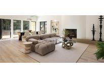 Comfortable living room with a tan sectional sofa, fireplace, and wall art is bright and inviting at 1130 Mclinden Se Ave, Smyrna, GA 30080