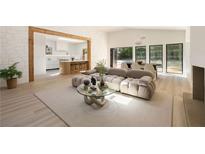 Bright, open-concept living room featuring modern furnishings, seamless flow to kitchen and outdoor views at 1130 Mclinden Se Ave, Smyrna, GA 30080