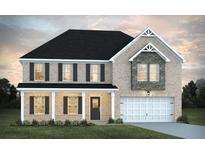 Charming two-story brick home with a welcoming front porch and attached two-car garage at 1672 Fuma Leaf Way, Mcdonough, GA 30252