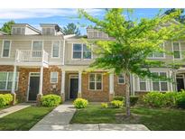 Charming townhome with inviting front yard, stone accents, and covered entrance offers a welcoming curb appeal at 2348 Bigwood Trl, Atlanta, GA 30349
