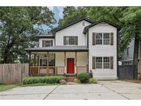 Charming two-story home with a welcoming front porch and a vibrant red door at 2411 Second Ave, Decatur, GA 30032