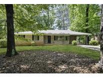 Charming brick home with a lush front yard and covered carport at 4400 Hickory Wood Ln, Atlanta, GA 30360
