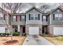 Attractive townhome with brick accents, attached garage, and well-maintained landscaping at 1155 Magnolia Gardens Walk, Mcdonough, GA 30253