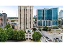 An exterior shot shows the high rise building with balconies and a swimming pool on top of the parking deck at 325 E Paces Ferry Ne Rd # 313, Atlanta, GA 30305