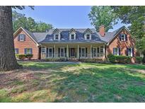 Charming brick home with dormer windows and a welcoming front porch at 3765 Cannonwolde Dr, Snellville, GA 30039