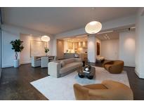 Spacious living room featuring modern decor, an open floor plan, and hardwood flooring at 1065 Peachtree Ne St # 3504, Atlanta, GA 30309