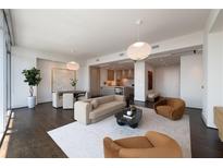 Bright open-concept living room featuring a dining area and stylish kitchen with modern appliances at 1065 Peachtree Ne St # 3504, Atlanta, GA 30309