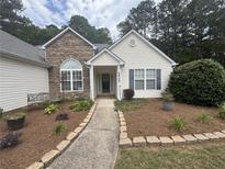 Charming home with stone accents, manicured landscaping, and a welcoming walkway at 2840 Alcovy River Vw, Dacula, GA 30019