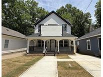 Charming two-story home with a covered front porch and freshly landscaped yard at 1090 Mcdaniel St, Atlanta, GA 30310