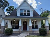 Charming home with a covered front porch, brick accents, and inviting curb appeal at 339 Morgan Se Pl, Atlanta, GA 30317