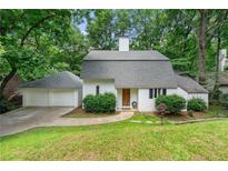 Charming home with a well-maintained lawn, mature trees, and a two-car garage at 4018 Dunbarton Ne Way, Roswell, GA 30075