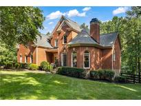 Charming two-story brick home with a well-manicured lawn and mature trees in a desirable neighborhood at 110 Wellington Way, Canton, GA 30115