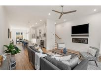 Inviting living room featuring an open floor plan, modern fireplace, and hardwood floors at 1237 Memorial Se Dr # 404, Atlanta, GA 30316
