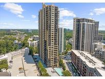 Stunning aerial view of high-rise condo building with parking and swimming pool in an urban neighborhood at 3481 Lakeside Ne Dr # 1107, Atlanta, GA 30326