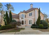 Elegant two-story home featuring lush landscaping and a well-manicured front yard at 971 Ashebrooke Ne Ct, Marietta, GA 30068