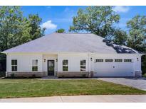 Charming single-story home with a white exterior, a gray roof, and an attached two-car garage at 614 Glendale Rd, Scottdale, GA 30079