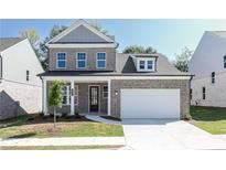 Charming two-story brick home with a welcoming front porch and a two-car garage at 1517 Ellie Ridge Ave, Lawrenceville, GA 30043
