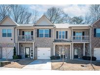 Charming townhomes feature brick and siding exteriors, garages, and small front yards at 2544 Castellan Dr, Atlanta, GA 30316