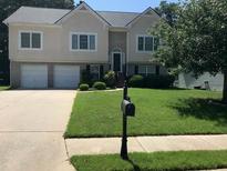 Traditional two-story home with a well-manicured front yard and a two-car garage at 318 Summit View Dr, Mcdonough, GA 30253