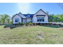 Beautiful single Gathering home with verdant lawn and landscaping at 2750 Herrington Dr, Cumming, GA 30041