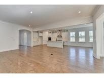 Bright open-concept living space with modern kitchen and hardwood floors at 2750 Herrington Dr, Cumming, GA 30041