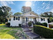 Charming single-story home with manicured landscaping and a welcoming front porch at 3215 Woodview Se Dr, Smyrna, GA 30082