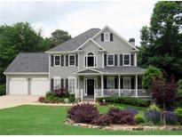 Charming two-story home with a well-manicured lawn, lovely landscaping, and a welcoming front porch at 21 Devin Lane Ln, Euharlee, GA 30145