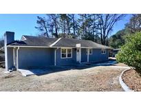 Charming single-story home featuring a classic design, landscaped yard, and inviting entrance, creating a warm and welcoming curb appeal at 1621 Oak Rd, Snellville, GA 30078