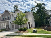 Two-story home featuring a well-manicured lawn, and attached two car garage at 338 Cherryhill Ln, Woodstock, GA 30188