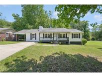 Charming one-story home with a welcoming front porch and beautifully maintained front yard at 3388 Hamilton Mill Rd, Buford, GA 30519