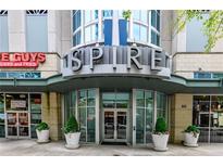 Condominium building entrance with architectural details and nearby businesses at 860 Peachtree Ne St # 1613, Atlanta, GA 30308