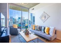 Cozy living room featuring a comfortable couch and a stunning city view at 860 Peachtree Ne St # 1613, Atlanta, GA 30308