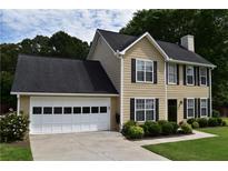 Charming two-story home with a two-car garage and manicured landscaping in a suburban neighborhood at 3109 Windgate Dr, Buford, GA 30519