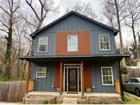 Charming two-story home featuring a modern blue exterior with a covered front porch at 1255 Plaza Sw Ave, Atlanta, GA 30310