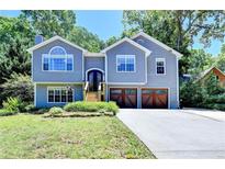 Charming two-story home with a well-maintained lawn and inviting front entrance with an attached two-car garage at 4751 Shay Ter, Buford, GA 30519