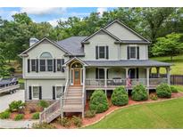 Charming two-story home with a welcoming front porch and manicured landscaping, perfect for Gathering gatherings and curb appeal at 1301 Ficklen Church Way, Canton, GA 30114