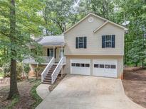 Charming two-story home with a two-car garage, a front porch, and a driveway at 459 Bakers Bridge Cir, Douglasville, GA 30134