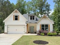 Charming one story home with a white exterior, complimented by wood accents and a well-manicured lawn at 3455 Henderson Dr, Cumming, GA 30041