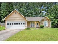 Charming single-story home with a two-car garage, stone accents, and a well-maintained lawn at 7847 Dogwood Way, Douglasville, GA 30134