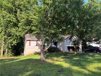 Charming home nestled among mature trees, featuring a well-maintained lawn and inviting curb appeal at 3230 Plymouth Rock Dr, Douglasville, GA 30135