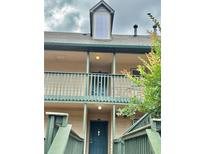 Two-story condo showcasing a balcony and neutral paint at 121 Brittany Ct, Duluth, GA 30096