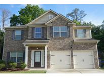 Charming two-story brick home with attached two-car garage and neatly maintained front yard at 1504 Gallup Dr, Stockbridge, GA 30281