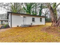 Charming home featuring a freshly painted white brick exterior, new fixtures, and landscaped front yard at 2162 Westover Dr, Atlanta, GA 30344