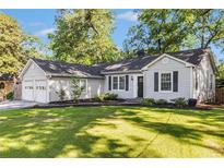 Charming single-story home with a well-manicured lawn and inviting curb appeal at 2701 Log Cabin Se Dr, Atlanta, GA 30339